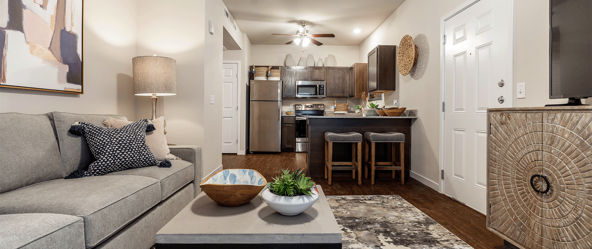 a living room with a couch and a kitchen in the background